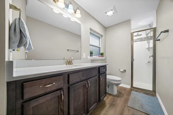 a bathroom with a sink a toilet and a mirror