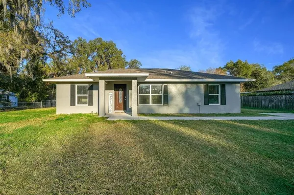 a view of a house with a backyard