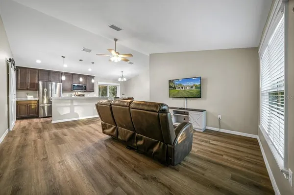 a living room with kitchen island furniture and a wooden floor
