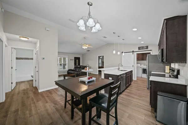 a kitchen with a dining table and chairs