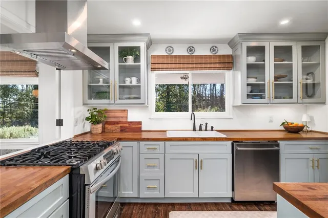 a kitchen with stainless steel appliances granite countertop a stove and a sink
