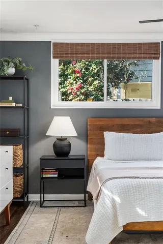 a bedroom with a bed and a chandelier