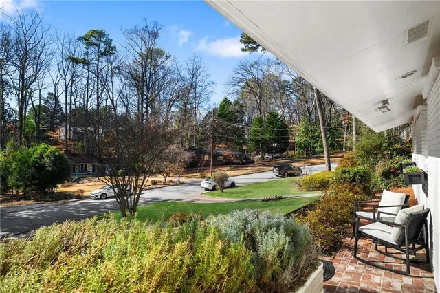 a view of swimming pool with lawn chairs and a big yard