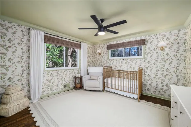 a bedroom with furniture and a large window
