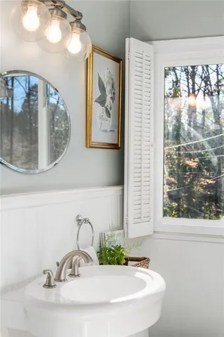 a bedroom with a bed and a large mirror with a desk