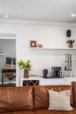 a view of a workspace with furniture and a window