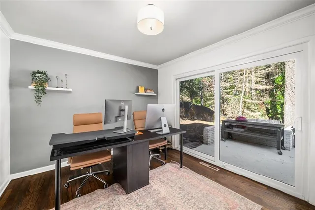 a view of a patio with table and chairs under an umbrella with wooden fence