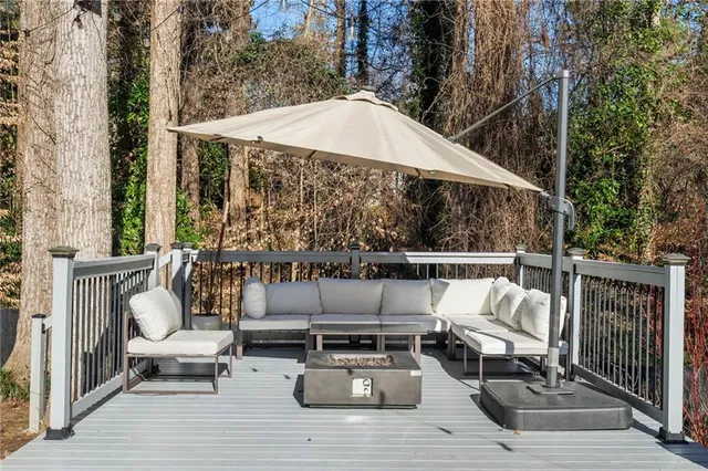 a view of a patio with a table and chairs under an umbrella