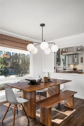 a kitchen with a table chairs and white cabinets