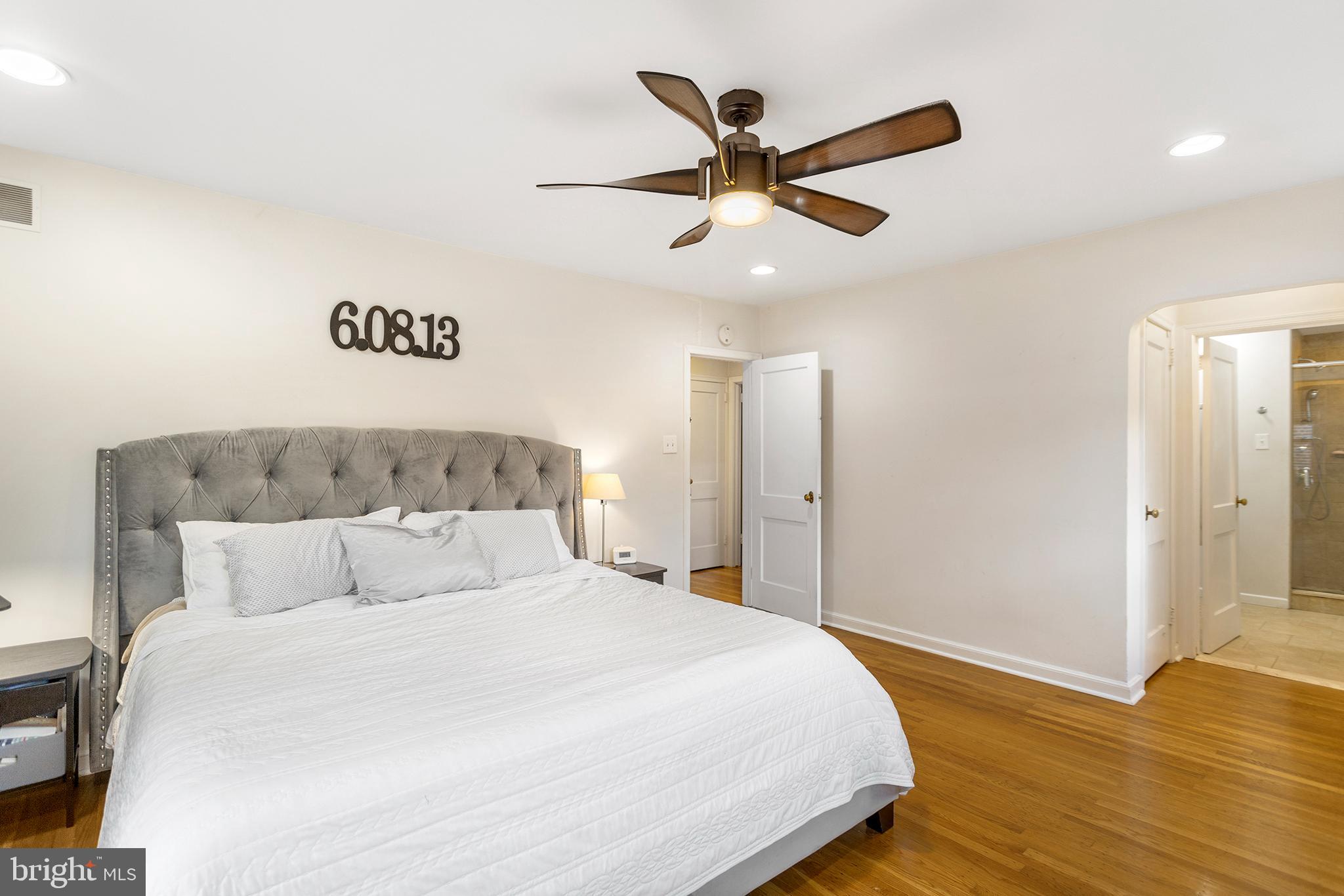 1806 Earlington Road Havertown, PA 19083 - Photo 19 of 27 a bedroom with a large bed and a chandelier