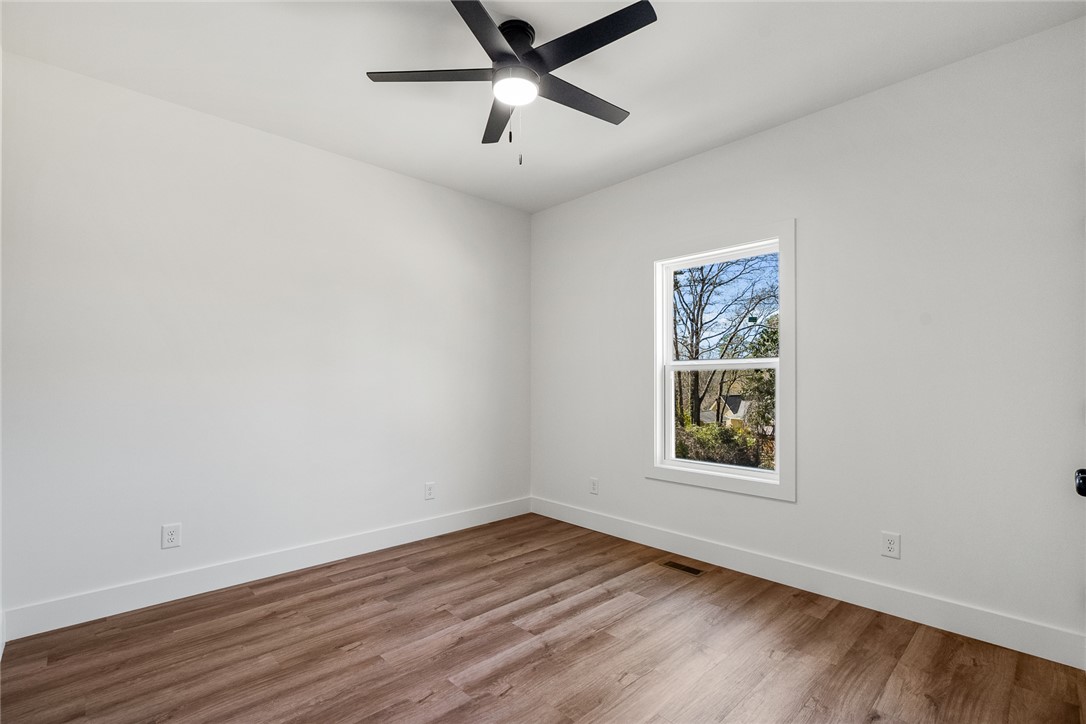 125 Cambridge Lane Pendleton, SC 29670 - Photo 14 of 22 This spacious room features ample natural light and durable wood flooring.