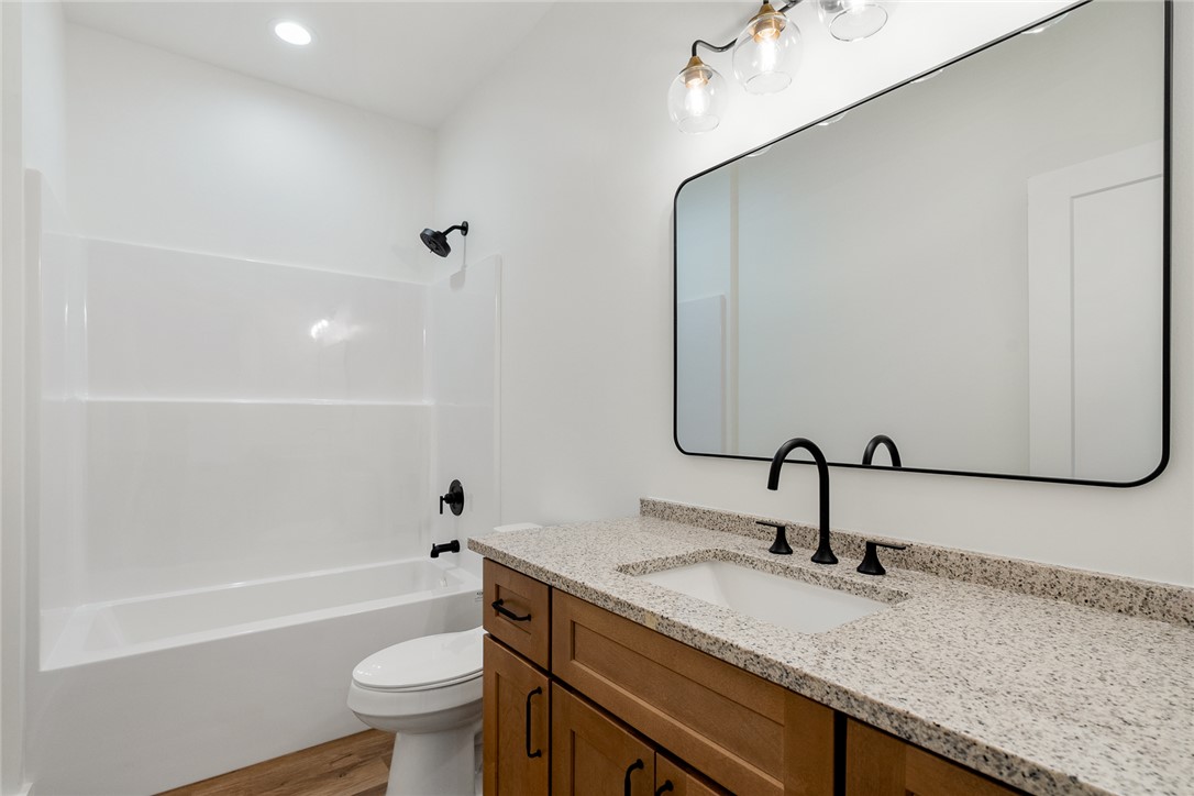 125 Cambridge Lane Pendleton, SC 29670 - Photo 15 of 22 This bathroom features a contemporary vanity with a spacious granite counter and modern fixtures.