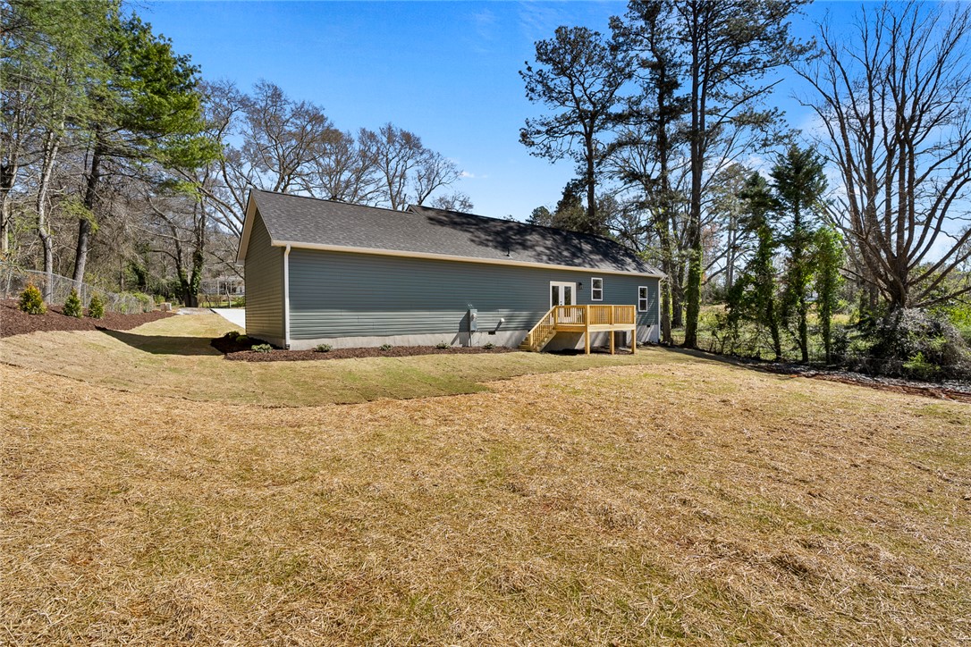 125 Cambridge Lane Pendleton, SC 29670 - Photo 19 of 22 This spacious backyard offers ample green space and a newly constructed deck, perfect for outdoor enjoyment.