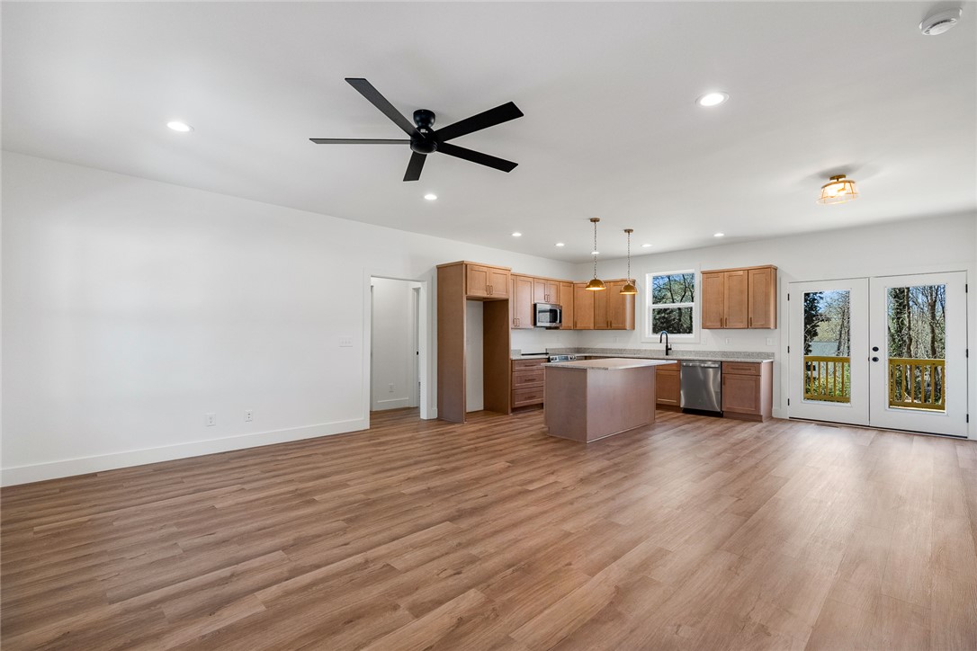 125 Cambridge Lane Pendleton, SC 29670 - Photo 3 of 22 This open concept space seamlessly connects living and kitchen areas, featuring stylish wood flooring.