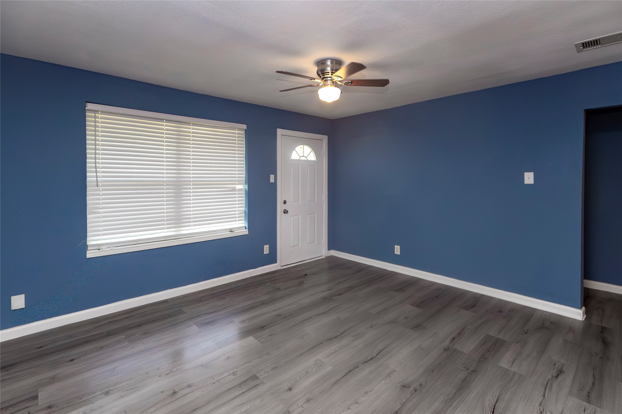 716 Hargest Street, Unit B Prairie View, TX 77445 - Photo 10 of 11 a view of an empty room with wooden floor and a window