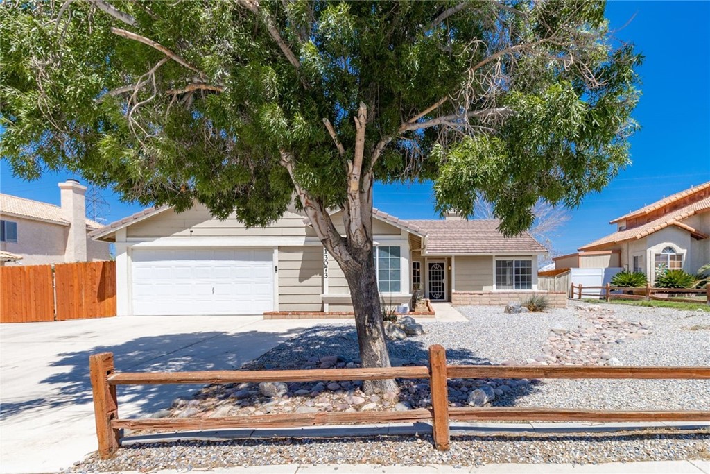 front view of a house with a tree