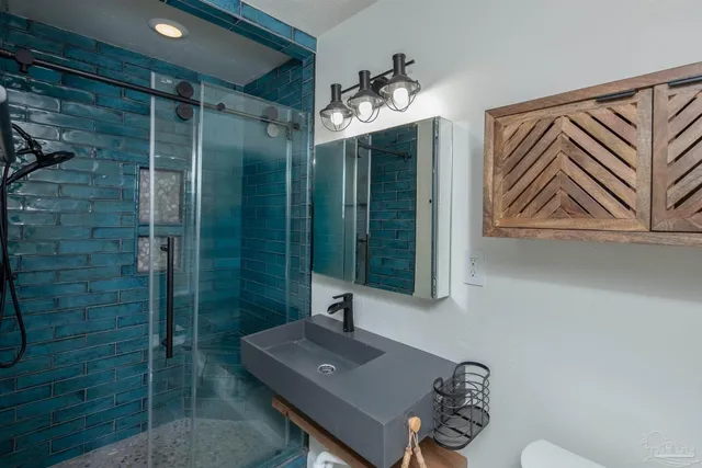 a bathroom with a sink a mirror and a shower