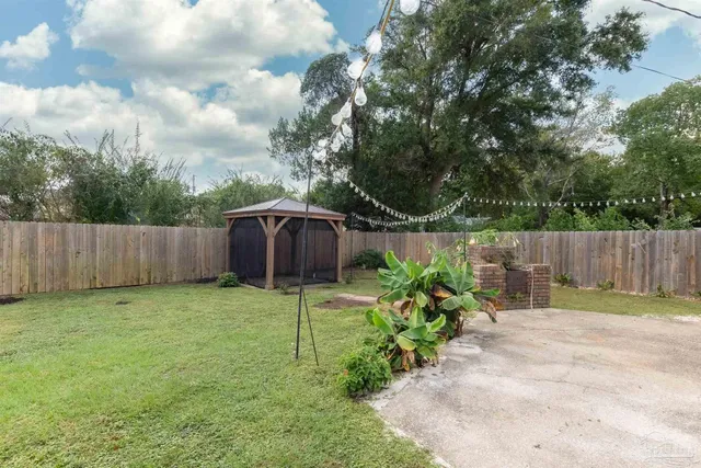 a backyard with wooden fence and a bench