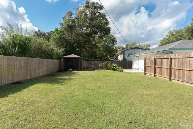 a backyard of a house with lots of green space