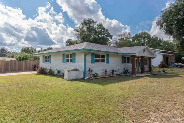 a view of a house with swimming pool and a yard