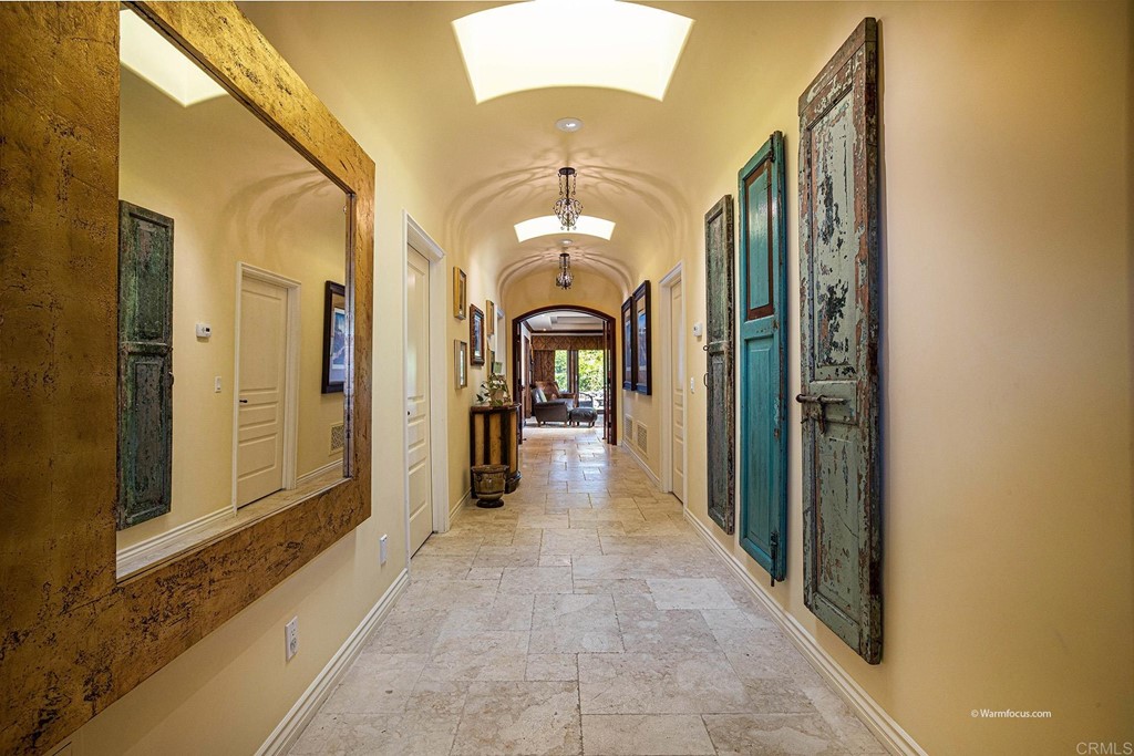 6103 Mimulus Rancho Santa Fe, CA 92067 - Photo 13 of 19 a view of a hallway with a chandelier