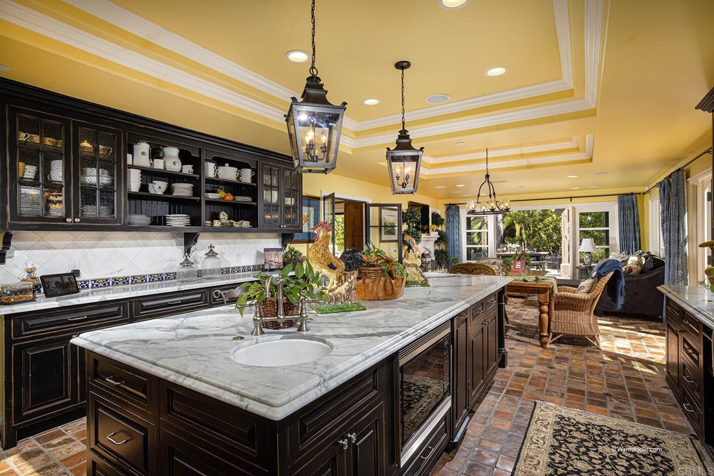6103 Mimulus Rancho Santa Fe, CA 92067 - Photo 6 of 19 a kitchen with a sink a counter and chairs
