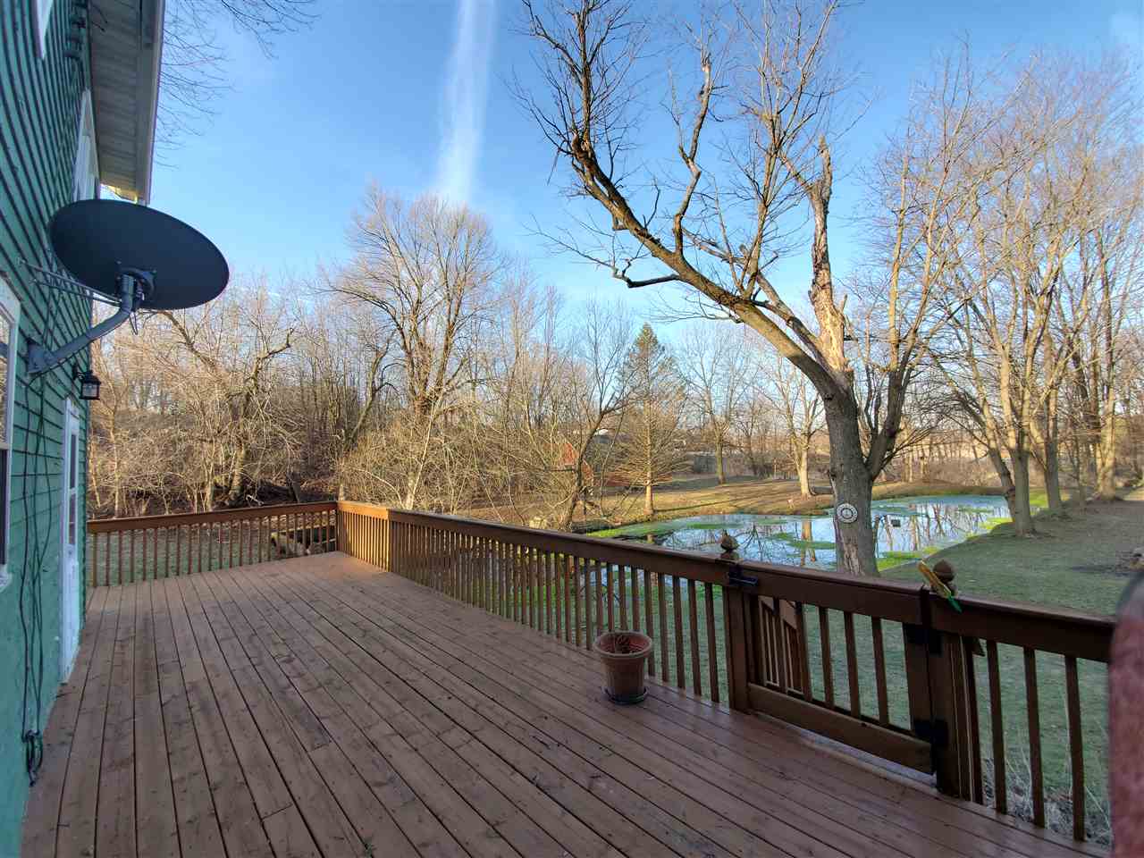 14375 West Springdale Road Forreston, IL 61030 - Photo 28 of 39 a balcony with wooden floor and a table and chairs