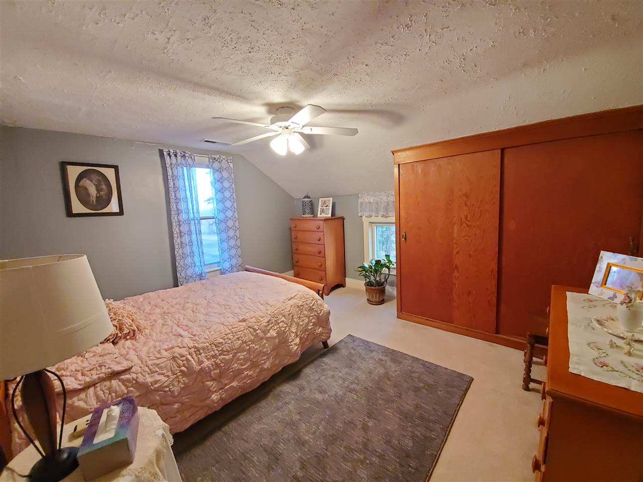 14375 West Springdale Road Forreston, IL 61030 - Photo 3 of 39 a bedroom with a bed and a chandelier