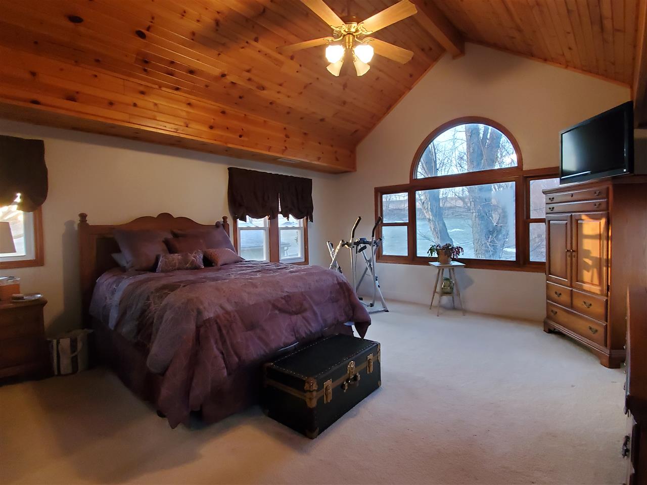 14375 West Springdale Road Forreston, IL 61030 - Photo 7 of 39 a spacious bedroom with a bed a mirror on table and windows