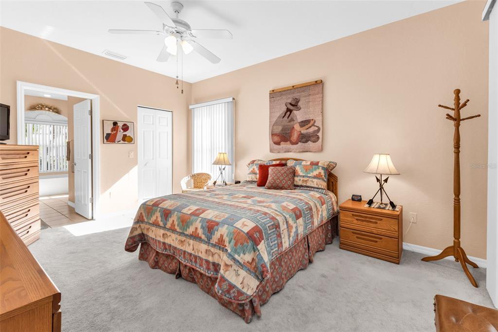 24116 Buckingham Way Punta Gorda, FL 33980 - Photo 12 of 42 a bedroom with a bed and a chandelier