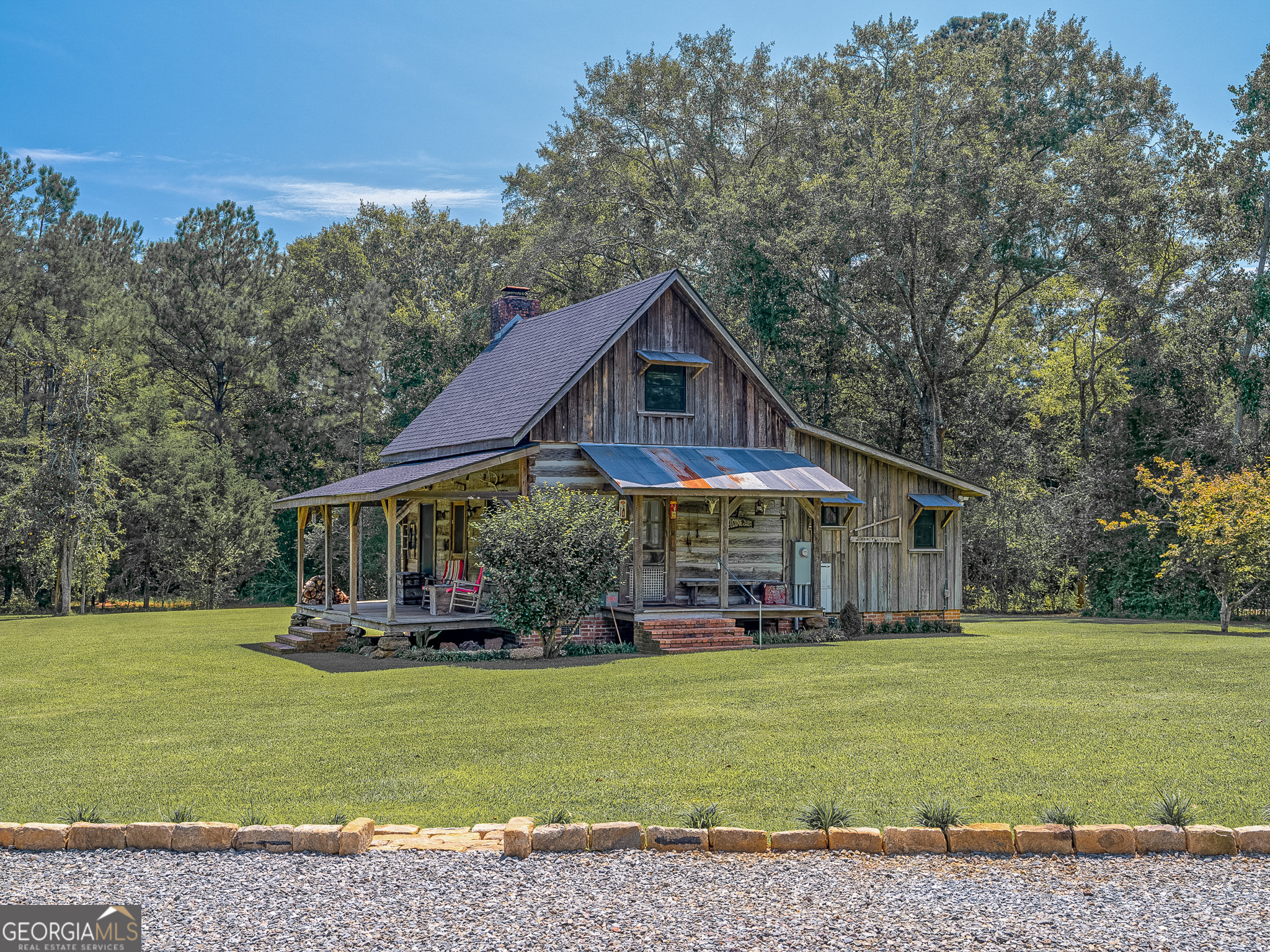 105 Buchanan Road Americus, GA 31719 - Photo 1 of 25 a front view of a house with a yard table and chairs