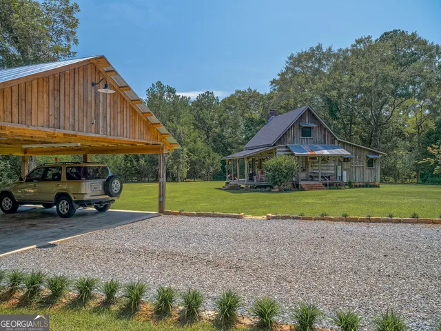 a view of house with outdoor space area and green space