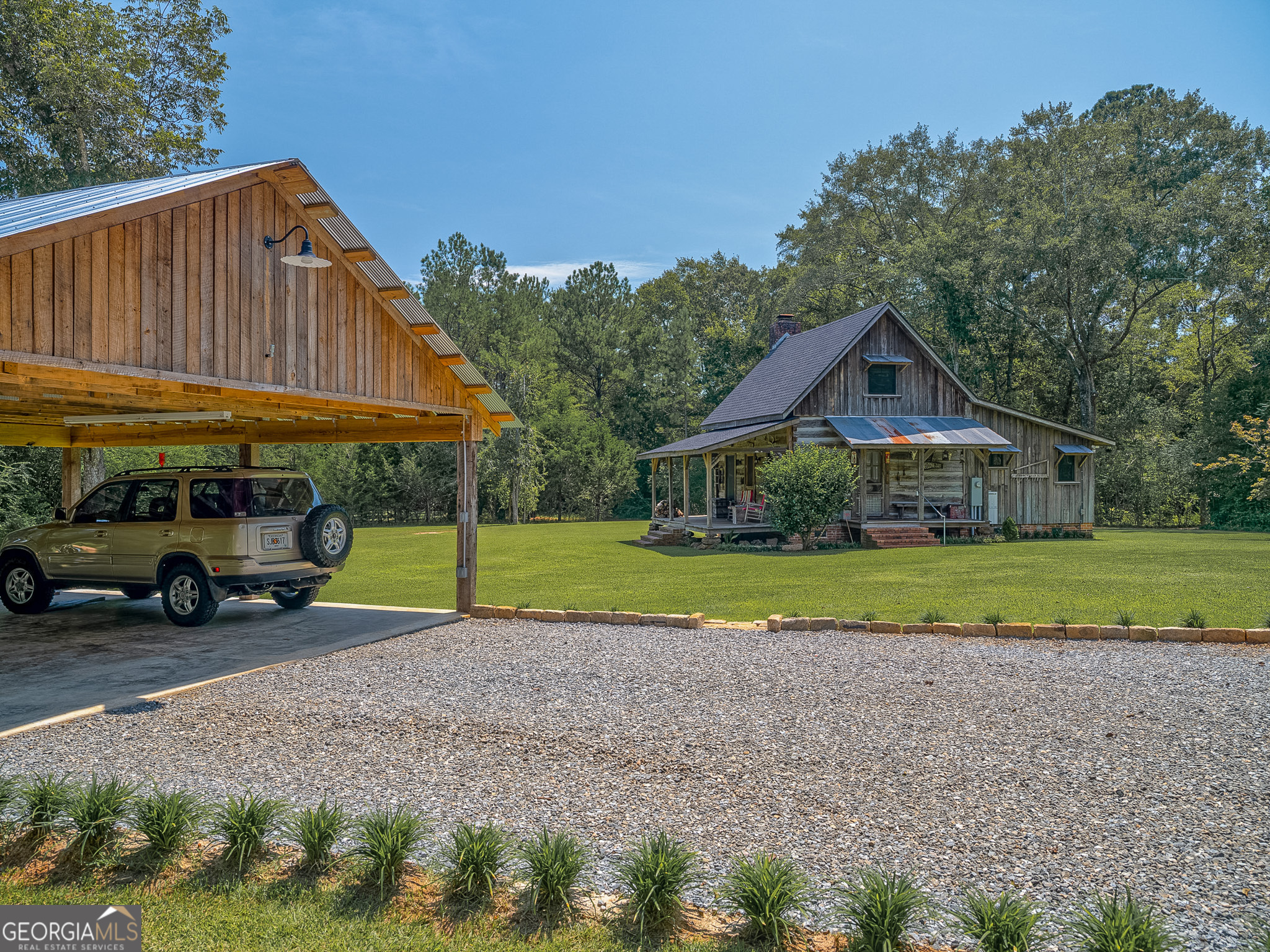 105 Buchanan Road Americus, GA 31719 - Photo 4 of 25 a view of house with outdoor space area and green space