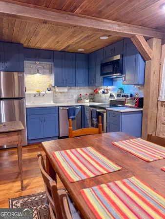 a kitchen with a stove a sink and a microwave