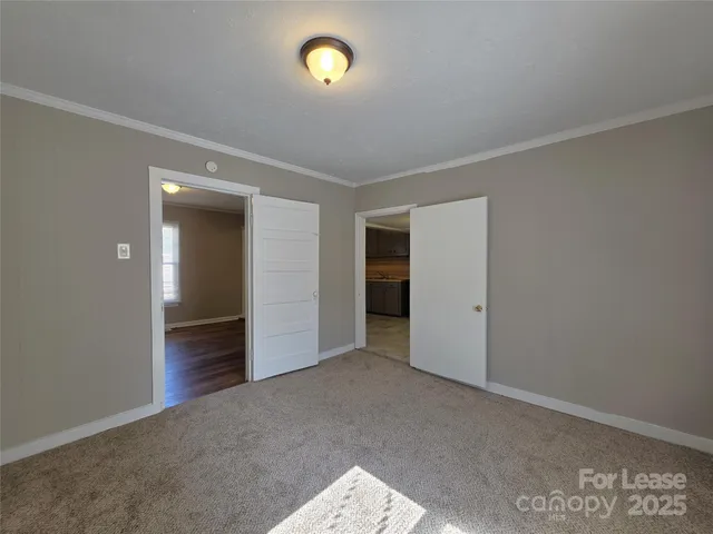 an empty room with closet and windows