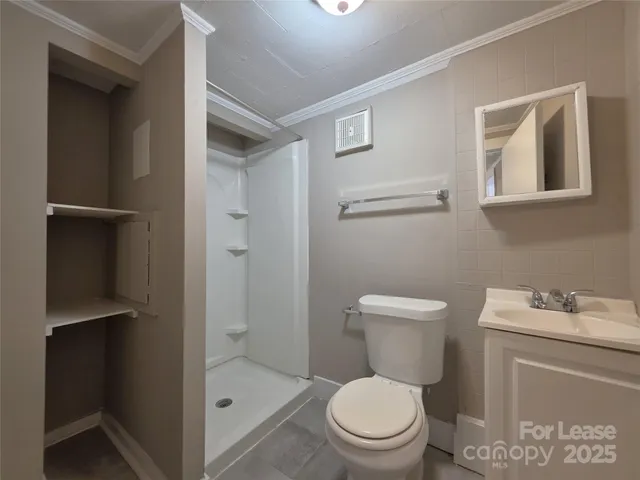 a white toilet sitting next to a bathroom sink