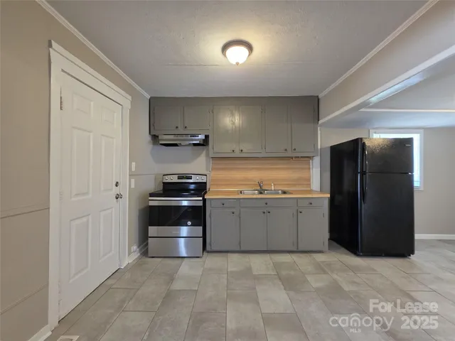 a kitchen with a refrigerator and a stove
