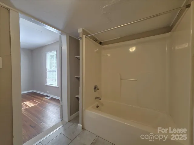 a bathroom with a bathtub and a shower