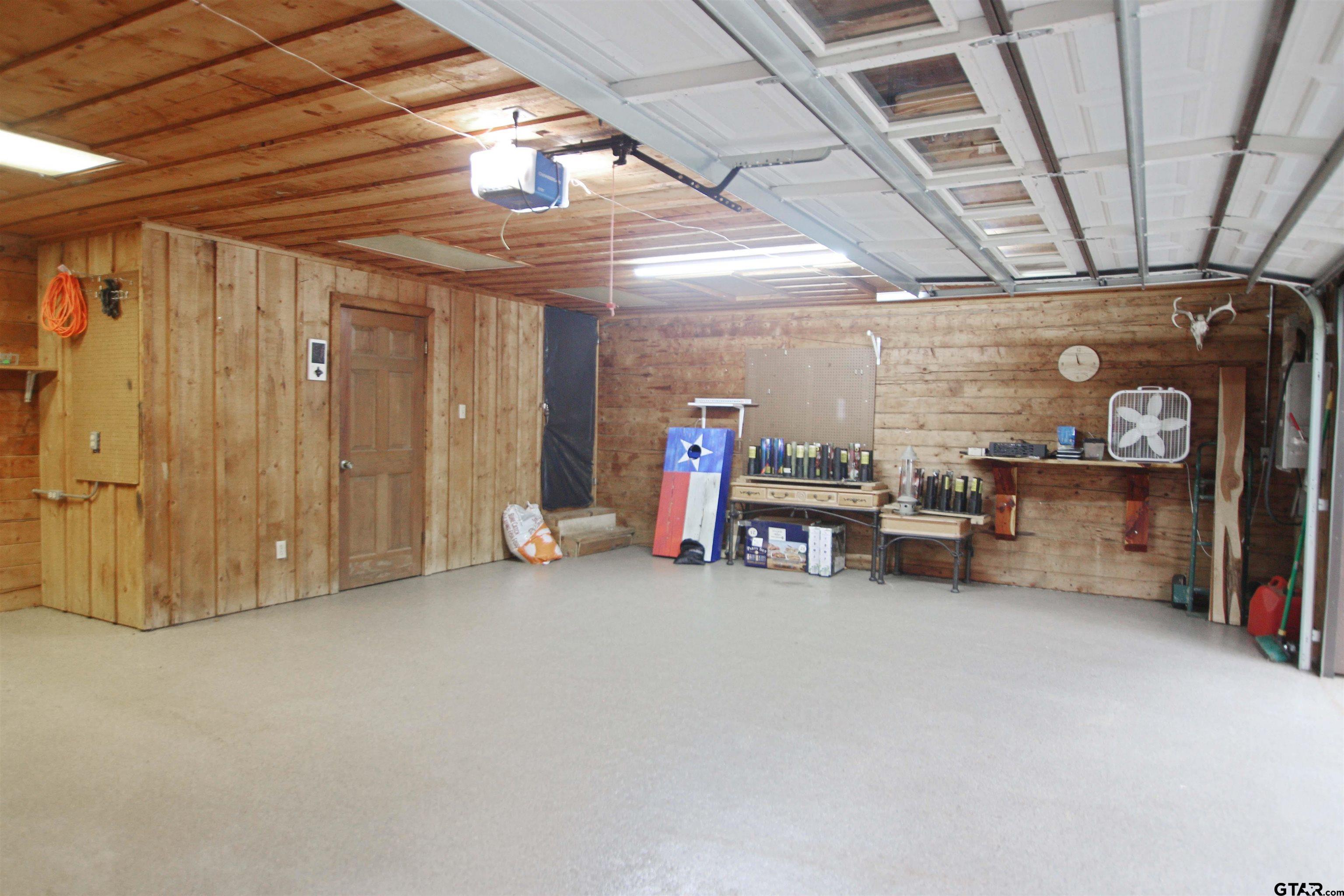 782 Rosie Wady Road Gladewater, TX 75647 - Photo 27 of 48 a view of a room with furniture and a garage