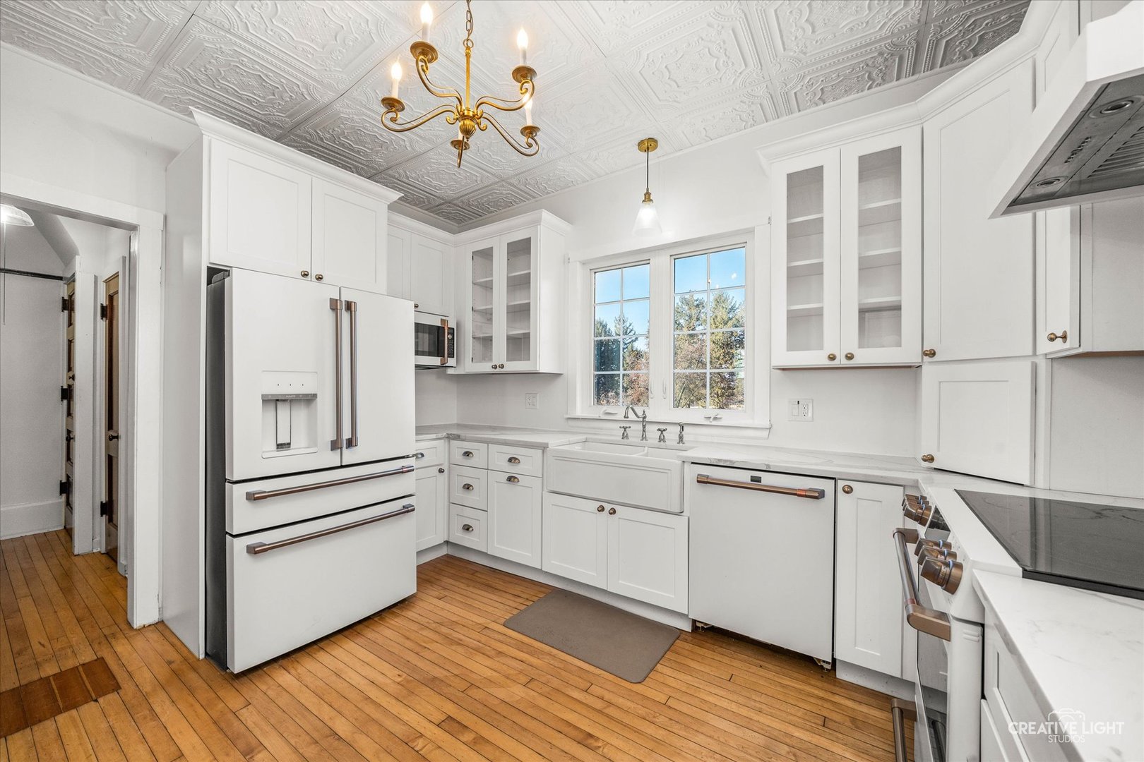 10256 Somonauk Road Hinckley, IL 60520 - Photo 11 of 44 a kitchen with a refrigerator and white cabinets
