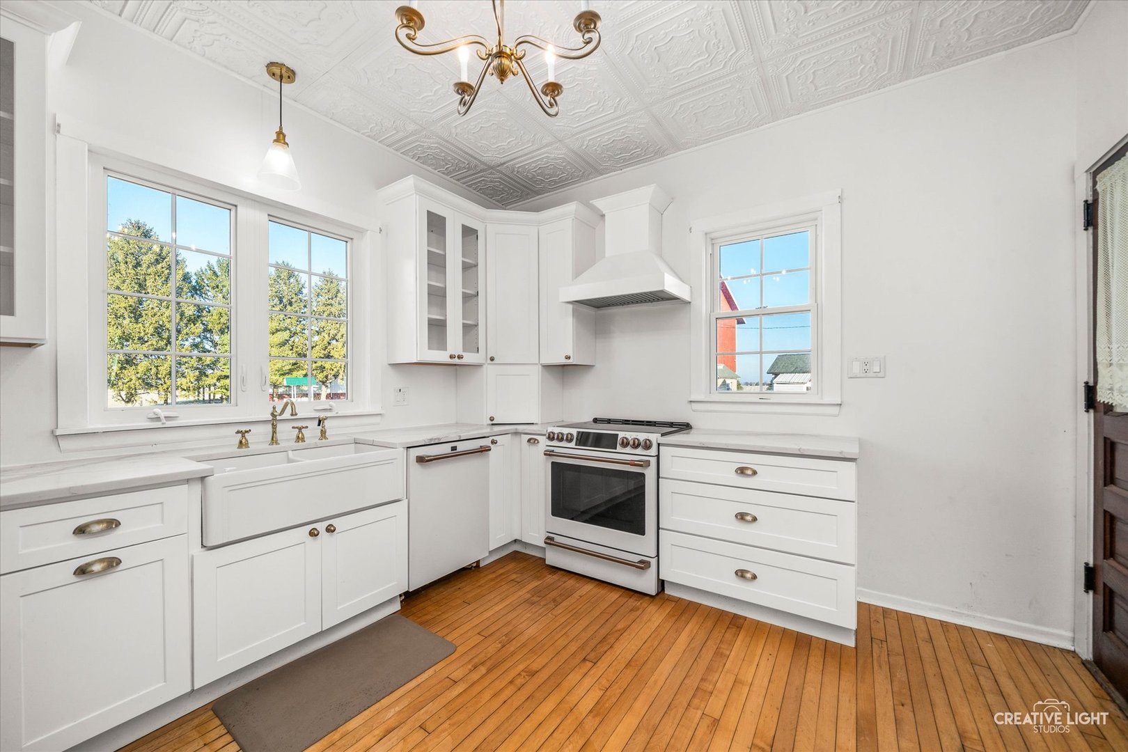 10256 Somonauk Road Hinckley, IL 60520 - Photo 12 of 44 a kitchen with stainless steel appliances a white cabinets and wooden floors