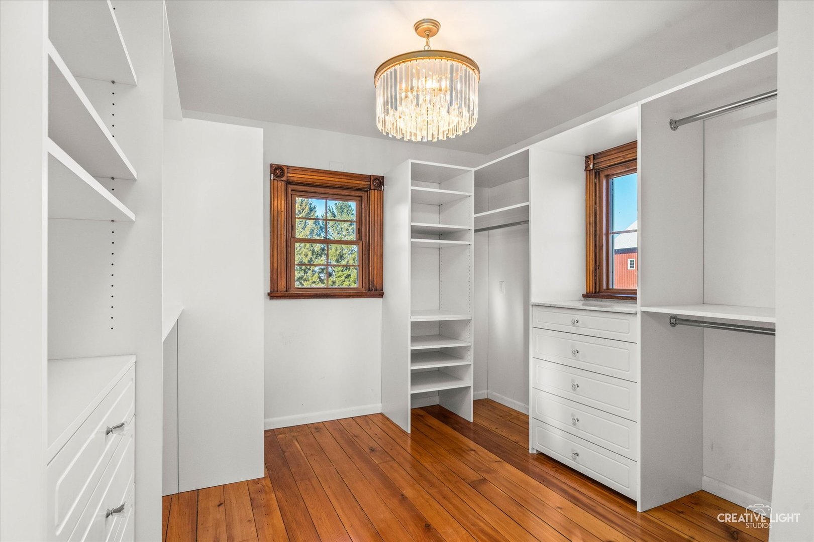 10256 Somonauk Road Hinckley, IL 60520 - Photo 14 of 44 a bedroom with a bed and a chandelier