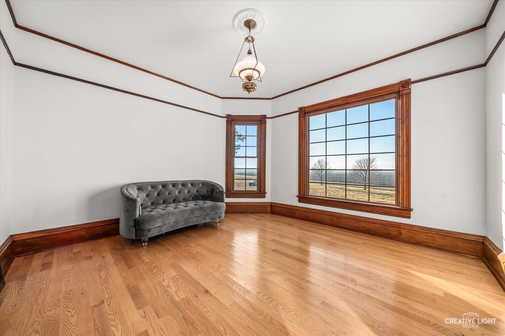 10256 Somonauk Road Hinckley, IL 60520 - Photo 5 of 44 a living room with a bed furniture and a chandelier