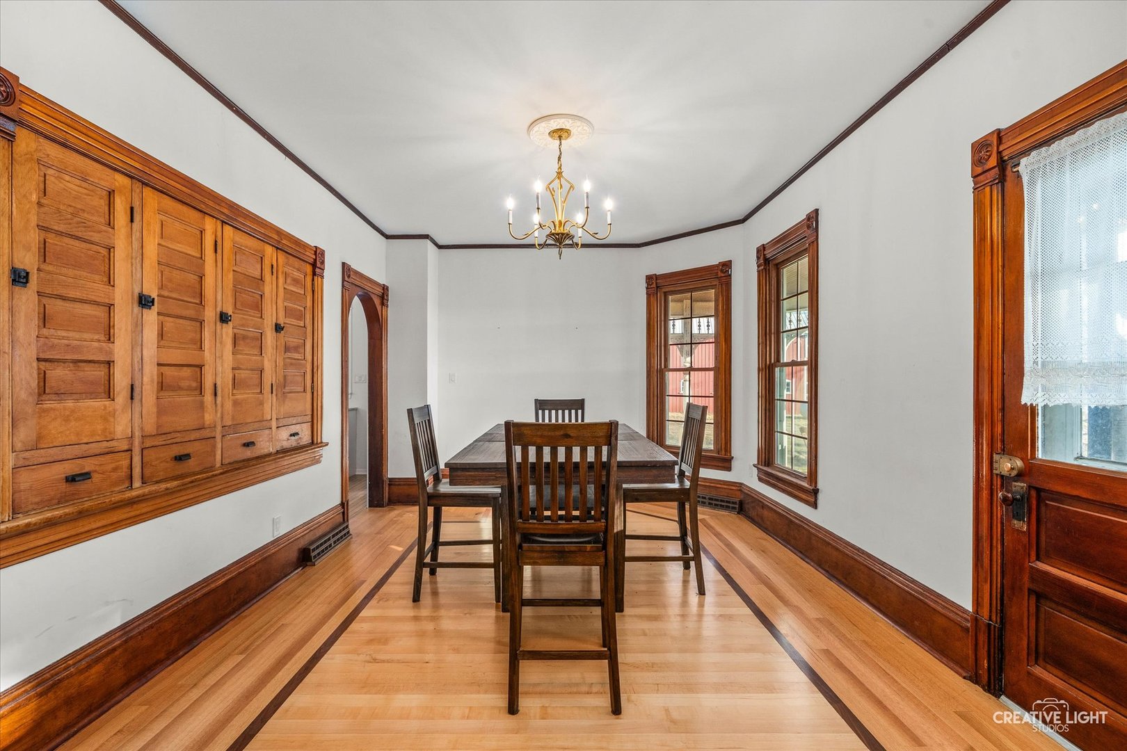 10256 Somonauk Road Hinckley, IL 60520 - Photo 10 of 44 a dining room with wooden floor a chandelier a wooden table and chairs