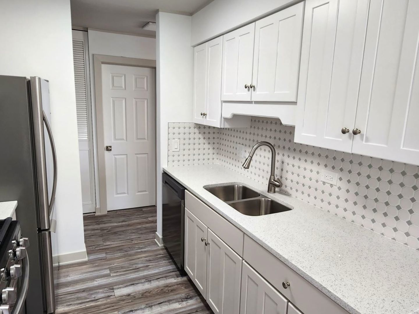 1500 Robin Circle, Unit 417 Hoffman Estates, IL 60169 - Photo 3 of 21 a kitchen with a sink and refrigerator