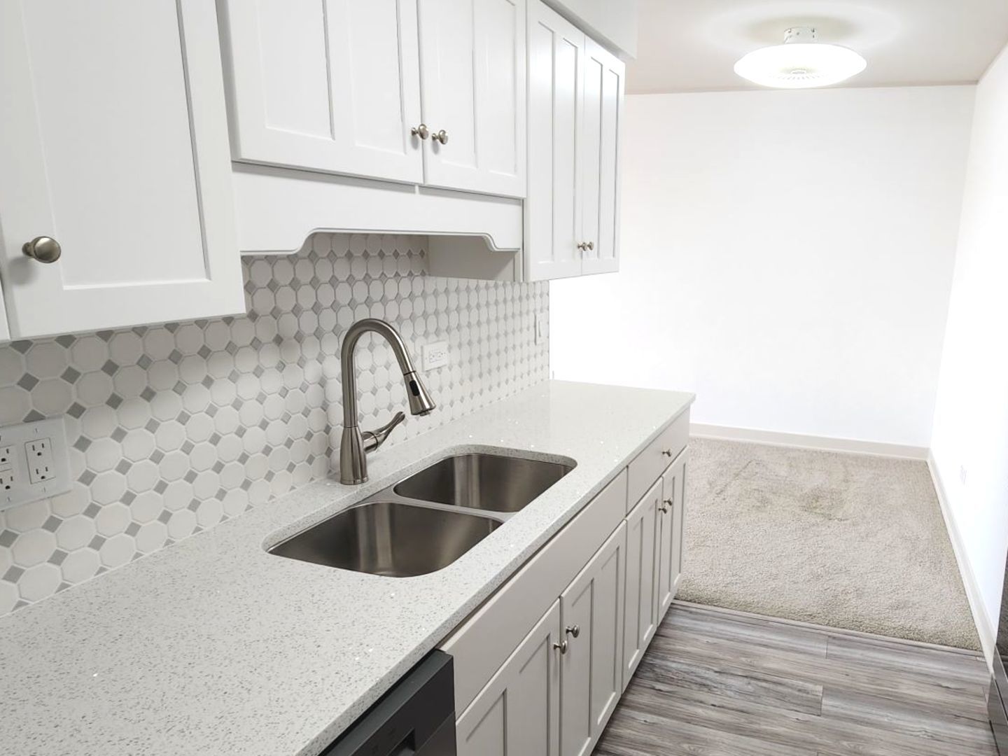 1500 Robin Circle, Unit 417 Hoffman Estates, IL 60169 - Photo 5 of 21 a kitchen with a sink and cabinets