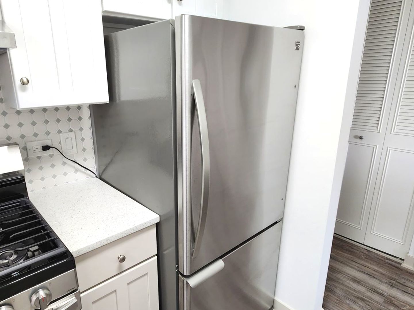 1500 Robin Circle, Unit 417 Hoffman Estates, IL 60169 - Photo 8 of 21 a close view of a refrigerator in kitchen and stainless steel appliances wooden floor