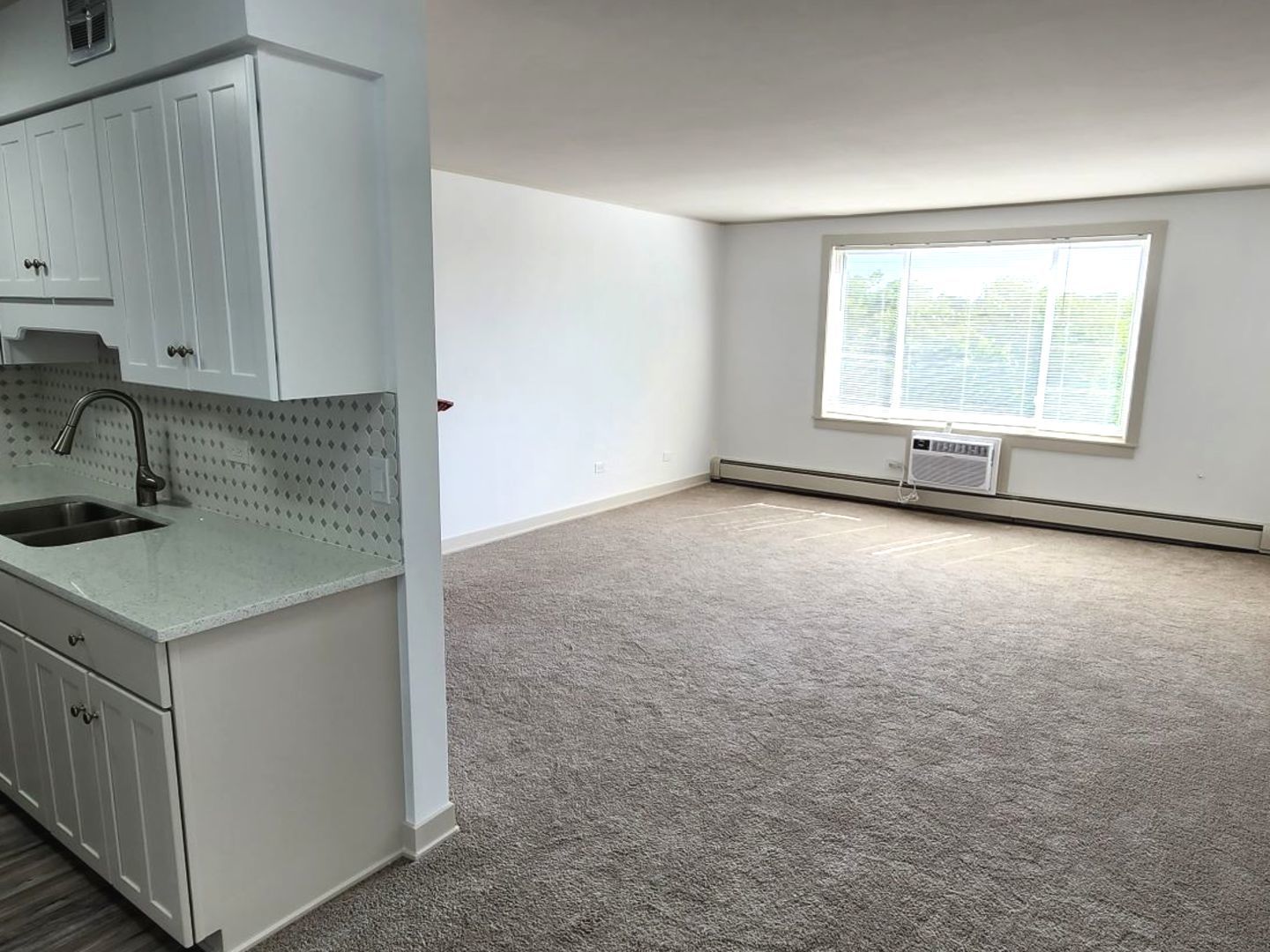 1500 Robin Circle, Unit 417 Hoffman Estates, IL 60169 - Photo 9 of 21 a kitchen with a sink cabinets and window
