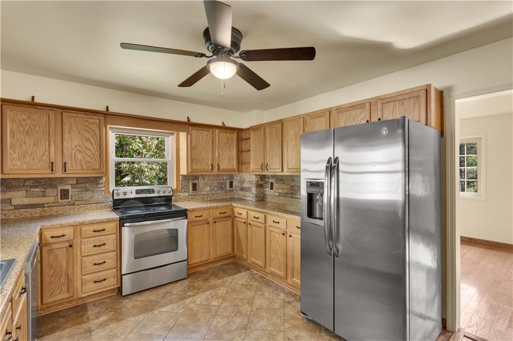 1585 Rte 481 Charleroi, PA 15022 - Photo 12 of 37 a kitchen with stainless steel appliances granite countertop a refrigerator a sink a stove and white cabinets