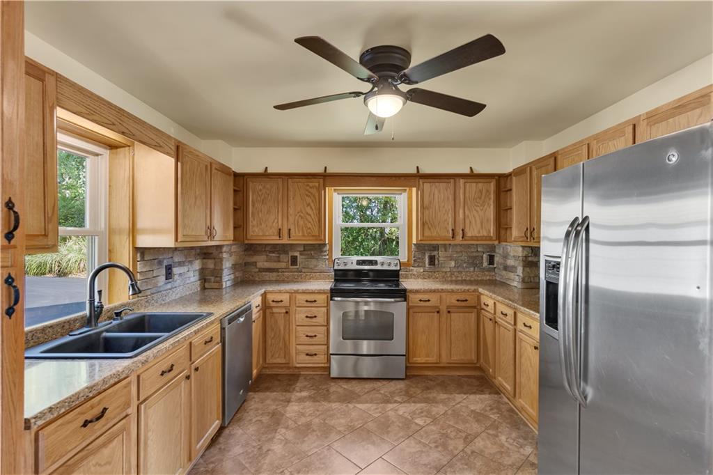 1585 Rte 481 Charleroi, PA 15022 - Photo 13 of 37 a kitchen with a sink refrigerator and cabinets